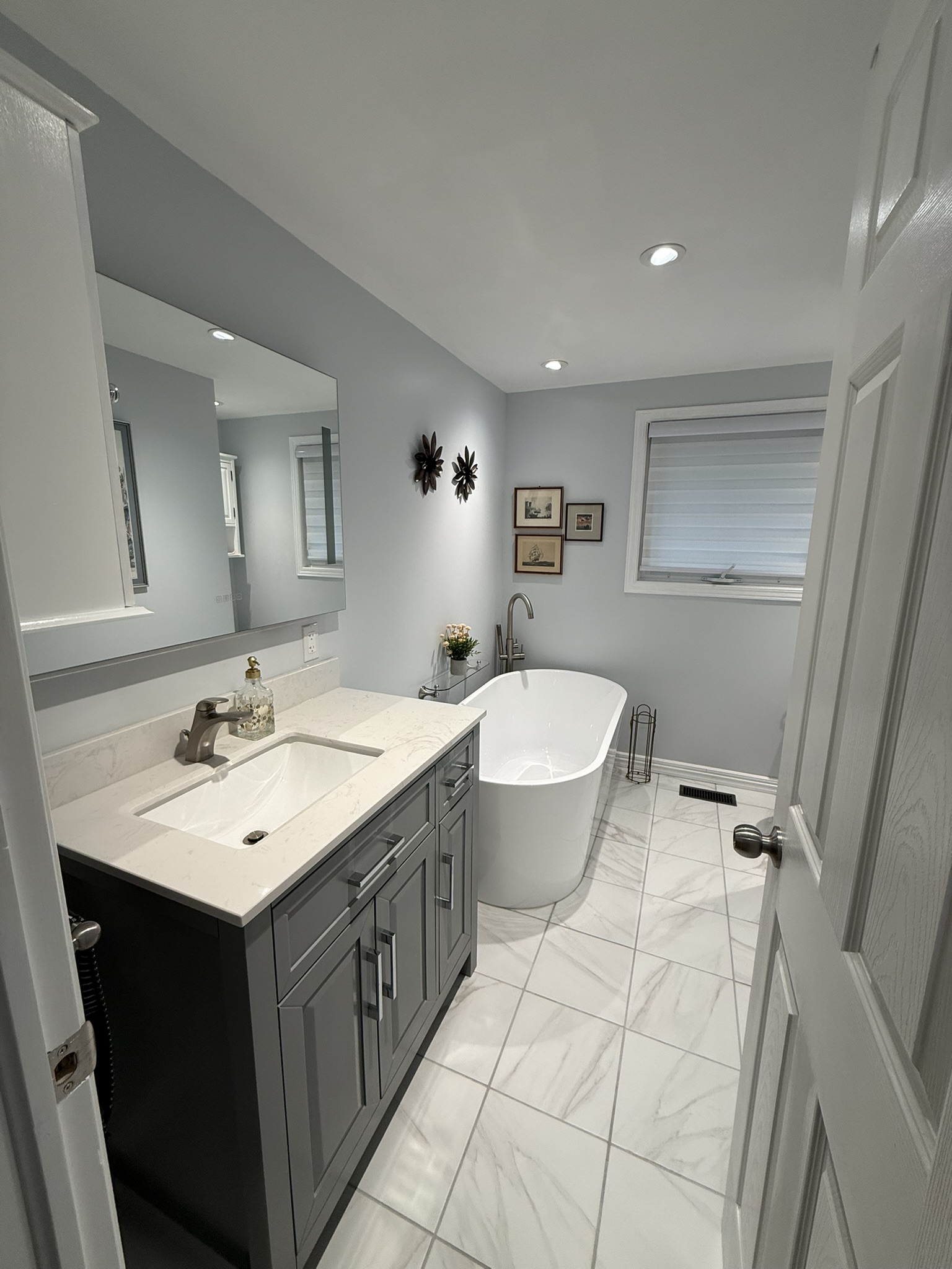 Primary bathroom with freestanding soaker tub and marble tile