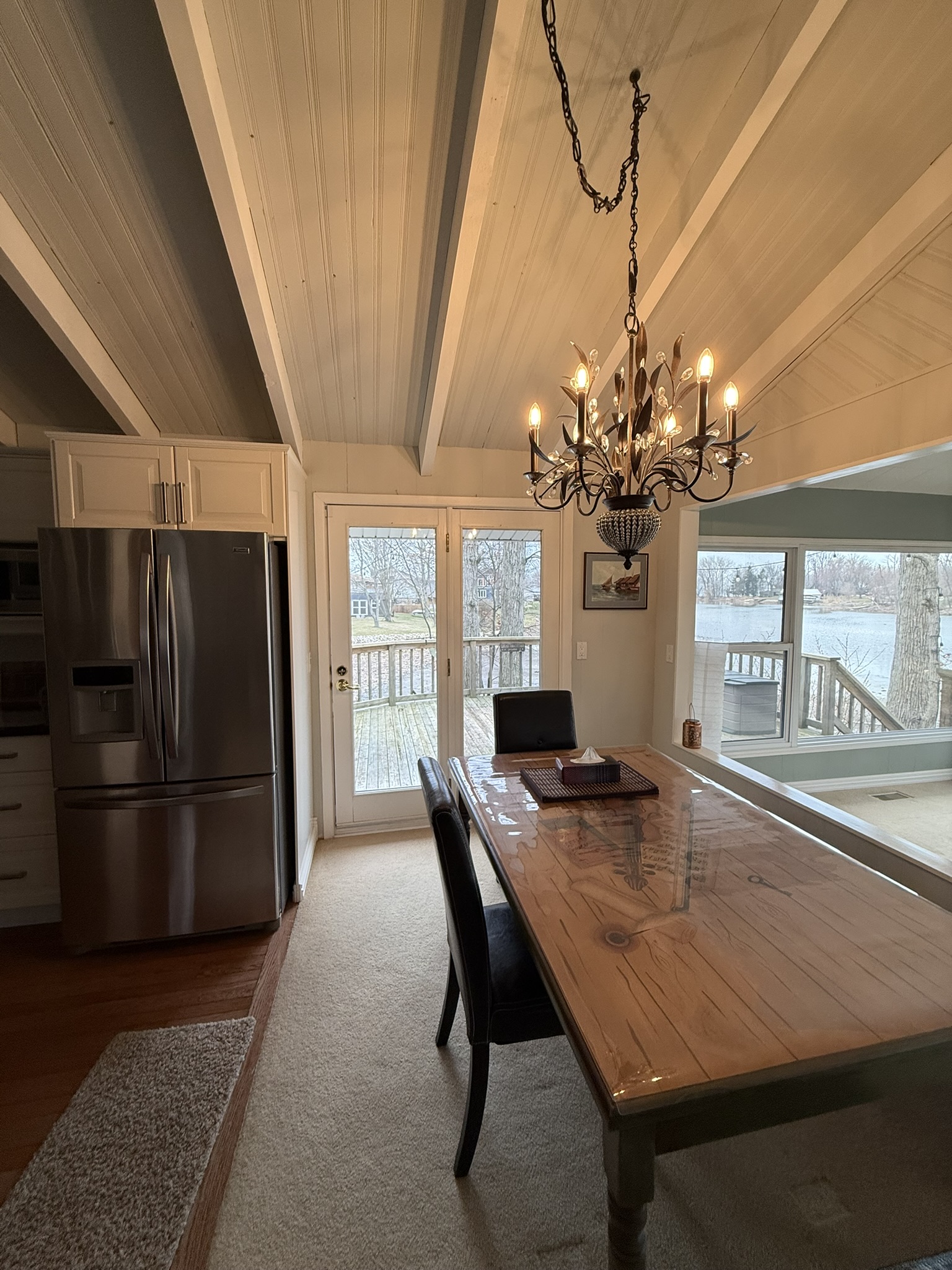 Dining room with vaulted beamed ceiling and chandelier