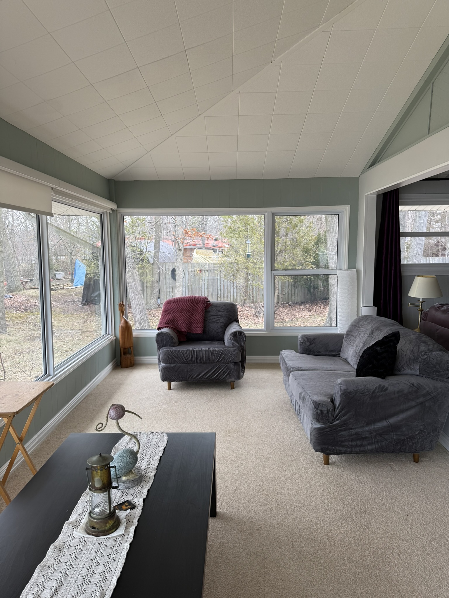 Sunroom living area with large windows