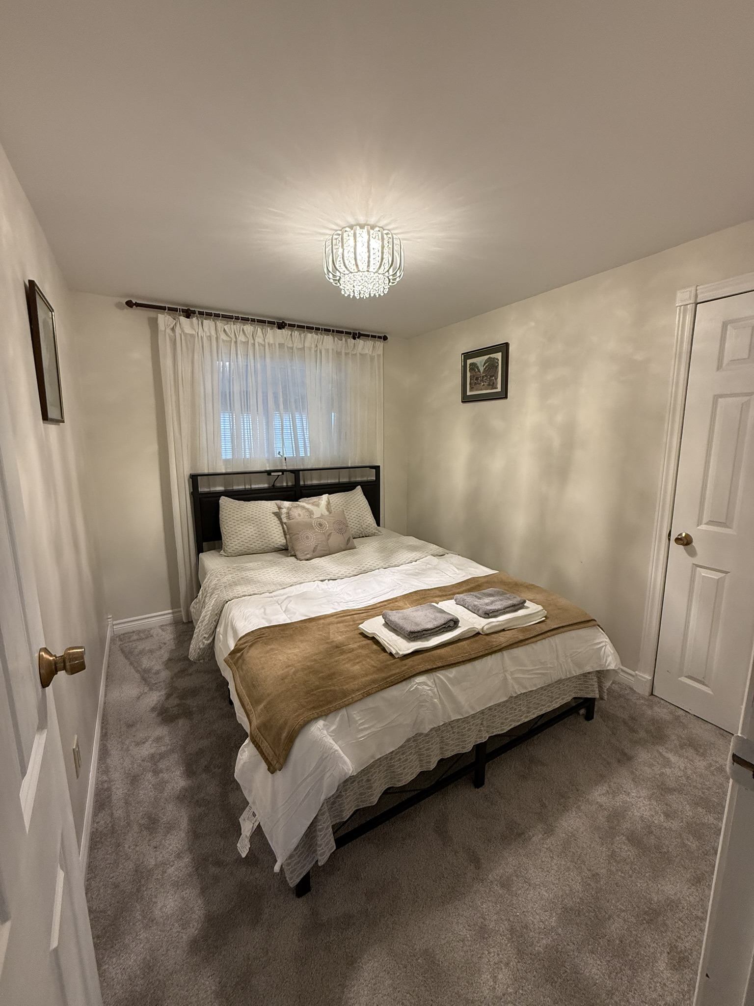 Bedroom 1 with queen bed and crystal chandelier